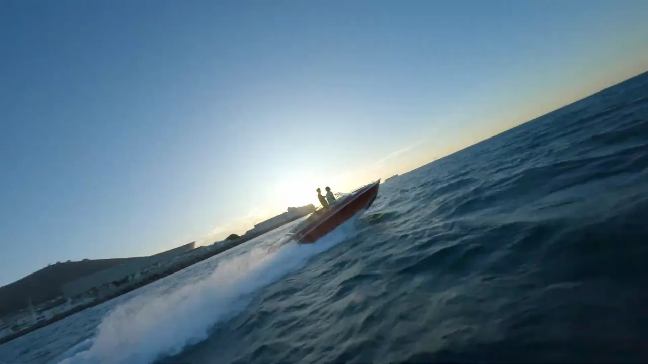Speedboat cutting across the bay at dawn