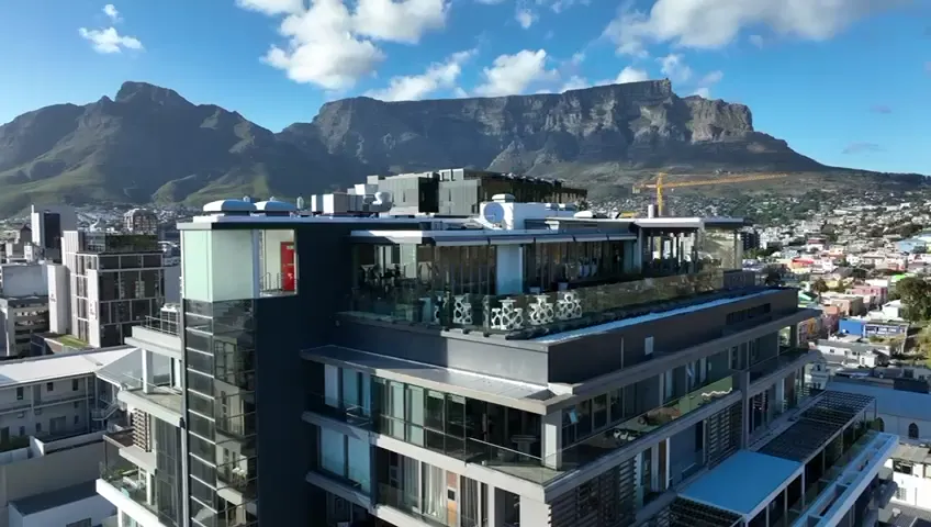 Apartment block with Table Mountain behind, property fly-through