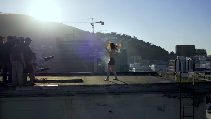 Dancer on a rooftop at sunset, orbited by FPV
